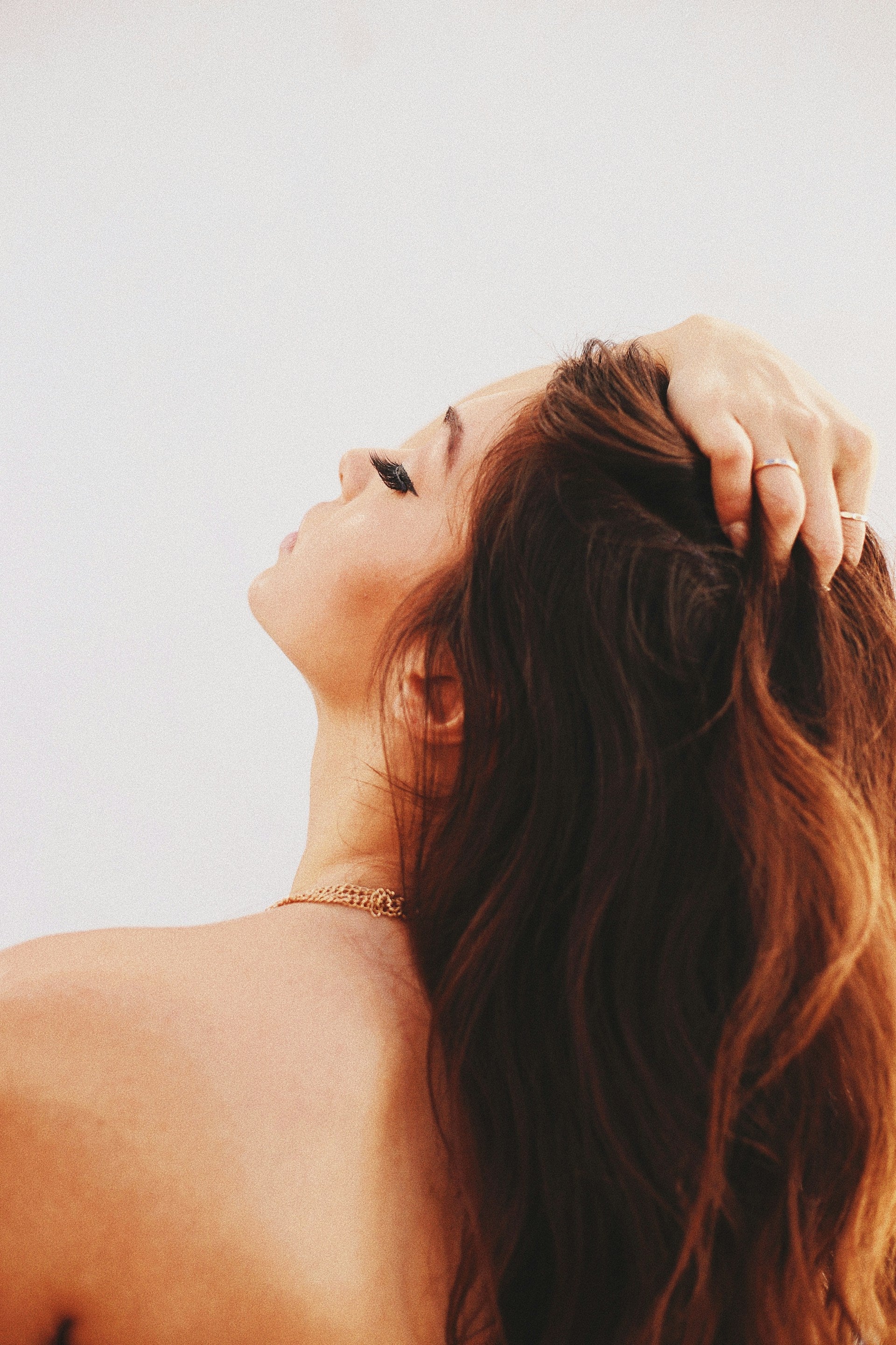 Woman holds her hair back showing healthy regrowing hair