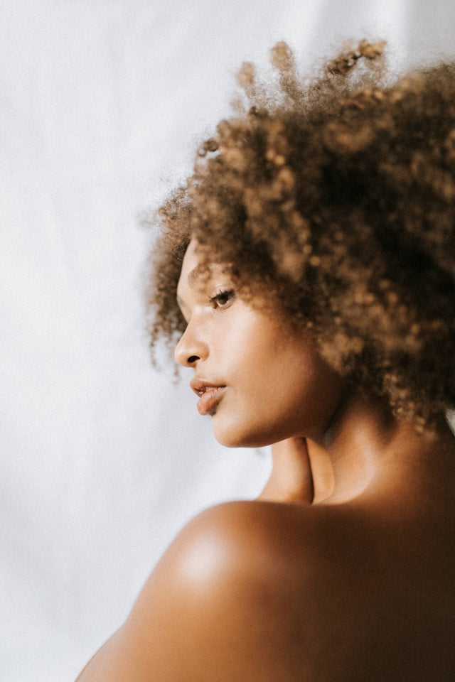 Beautiful side profile image of woman with curls